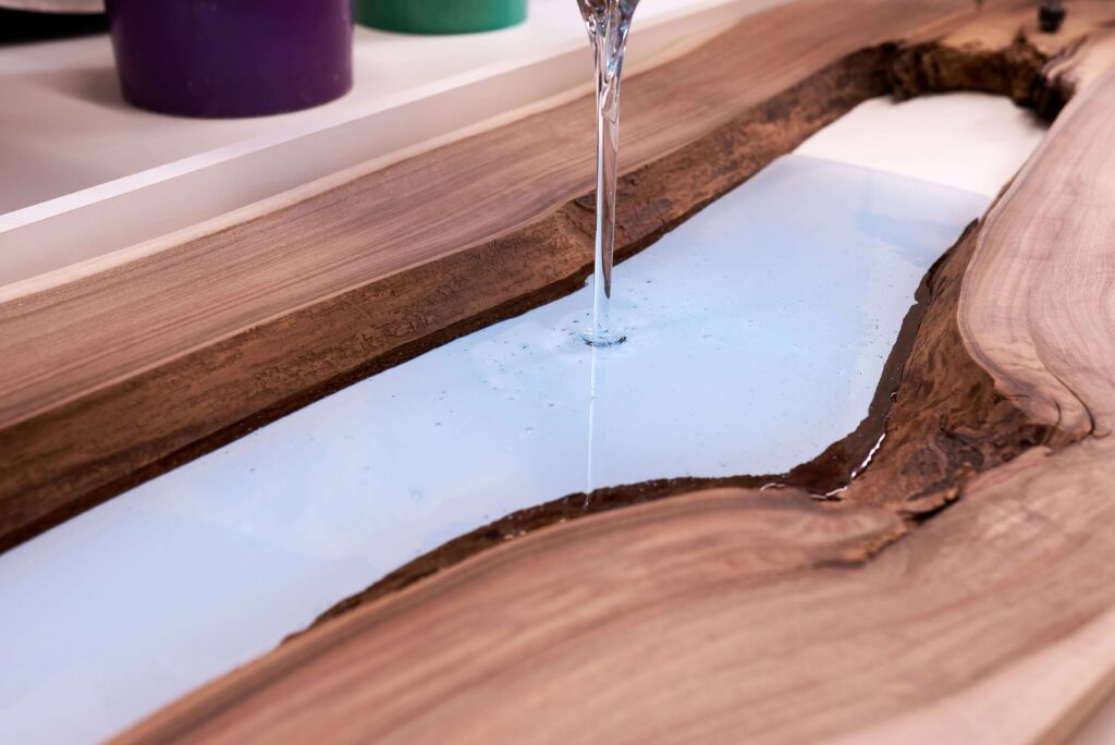 Pooring Clear Epoxy into live edge table - Anglewood Toronto